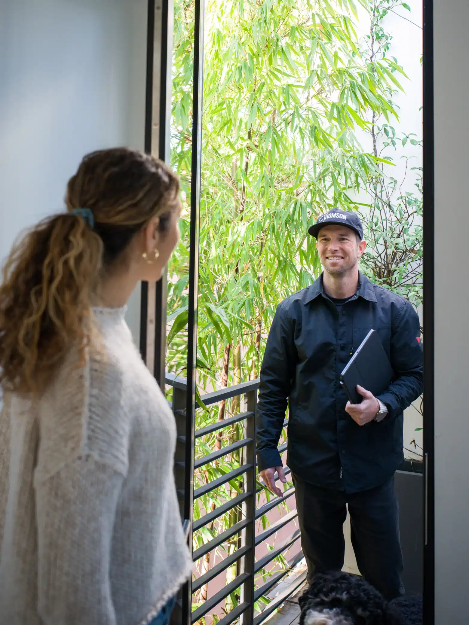 Thomson team member greeting a homeowner at the door