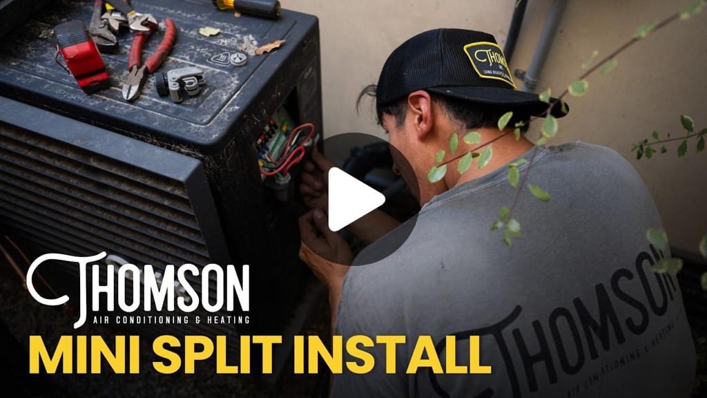 Thomson technician installing a second Quilt mini split head unit in a Seal Beach living room