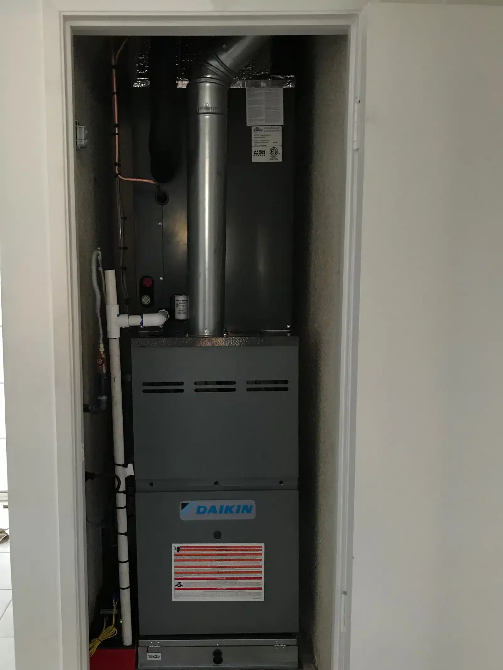 New Daikin gas furnace installed in a hallway closet
