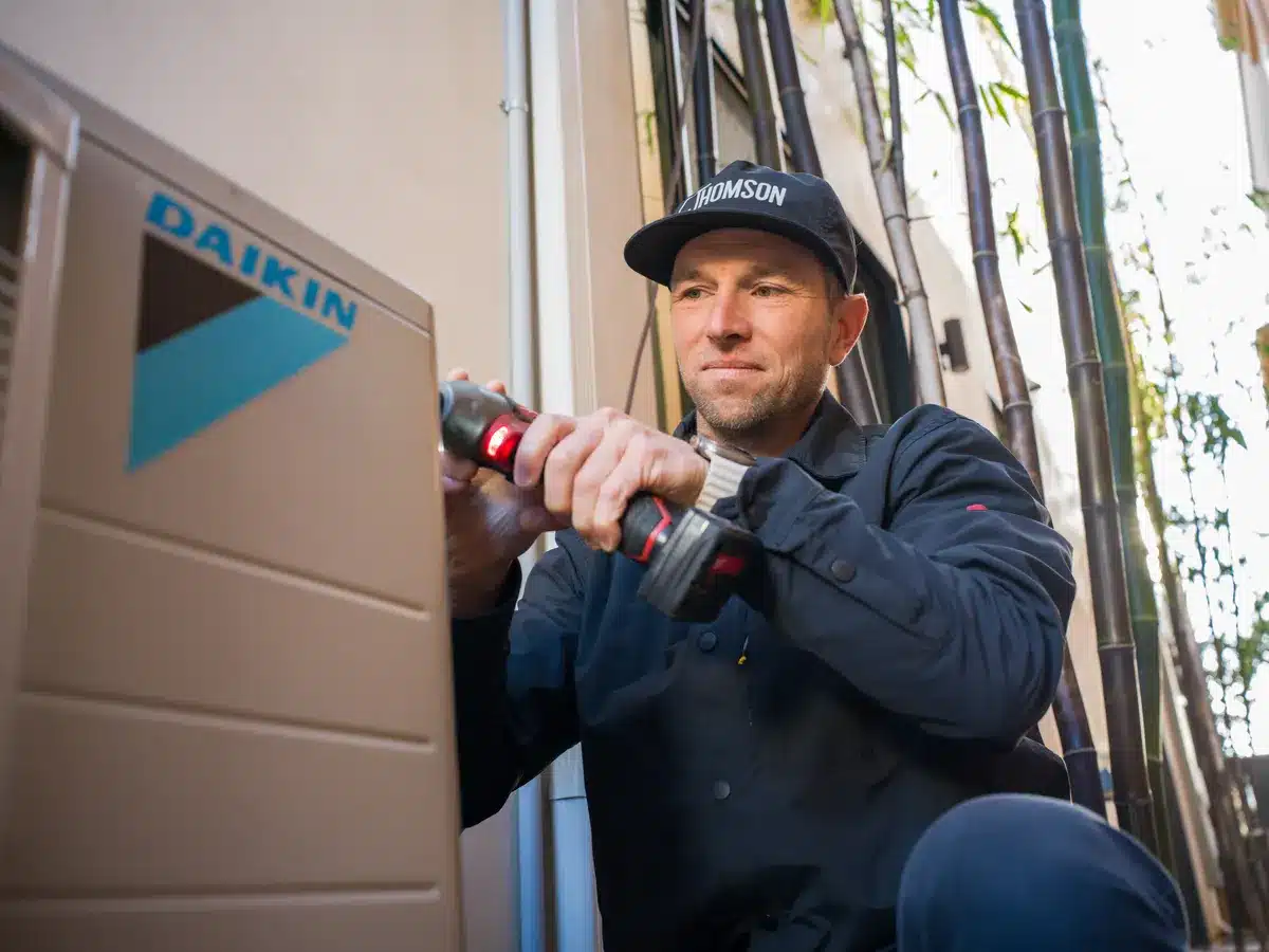 Thomson technician installing an outdoor AC unit