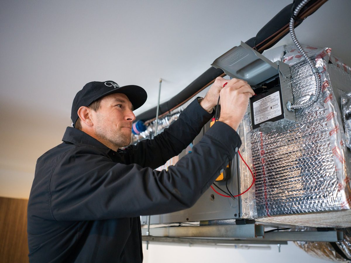 Thomson AC technician testing an air handler