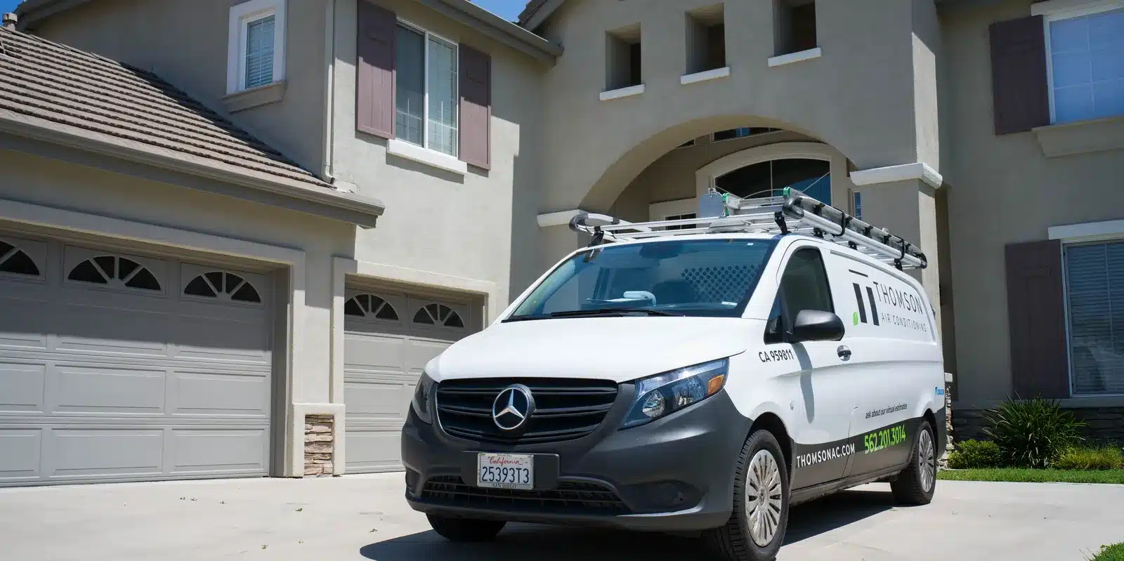 Thomson AC service van parked outside a two-story home